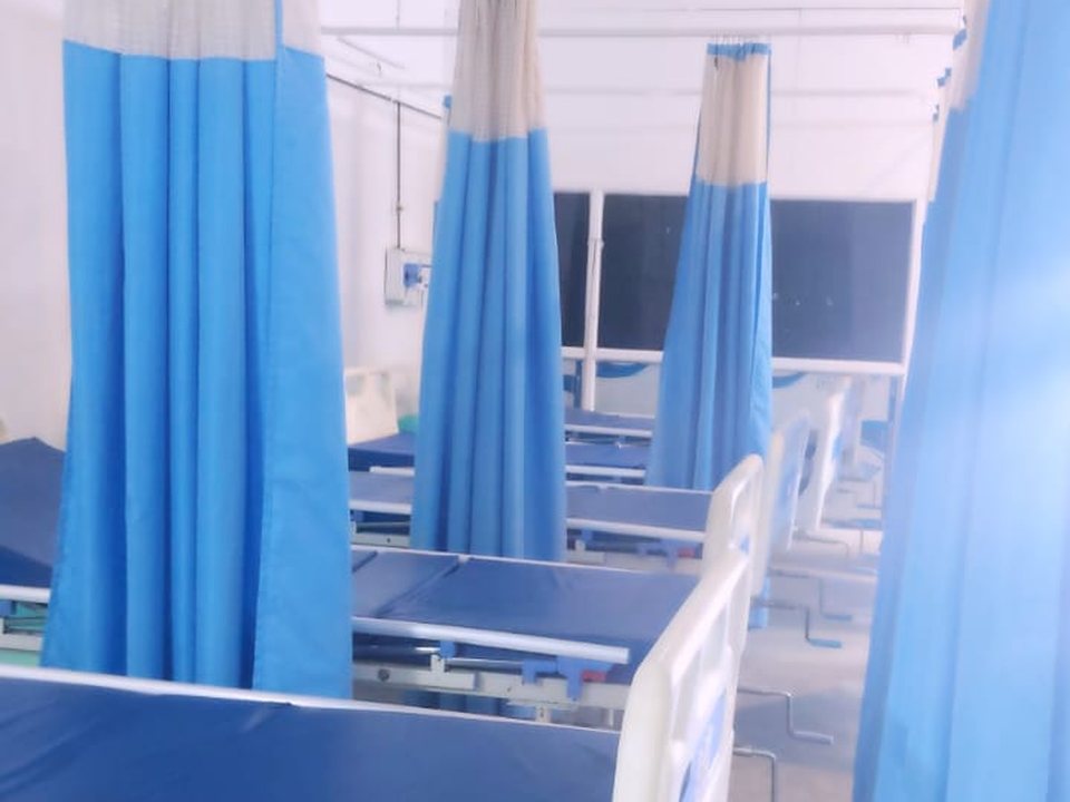 In-patient ward with beds and privacy curtains at Shahnaz Hospital